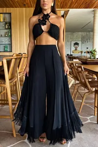 Full view of elegant black high-waisted wide-leg trousers with fringe hem detailing