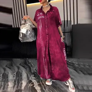 Macro view of burgundy denim shirt dress featuring white fashion letter print and collar