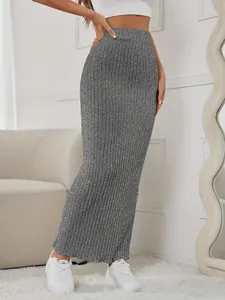 Detailed view of gray ribbed knit maxi skirt featuring slim fit and elastic waist.