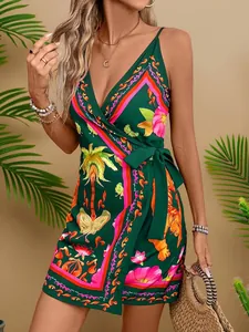 Close-up of a green tropical print wrap dress with V-neck and tie waist details