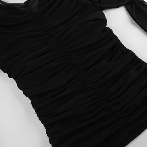 Close-up detail of black ruched mesh top showing sheer fabric and pleated texture