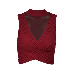 Close-up detail of wine red ribbed knitted crop top with stylish crisscross wrap design