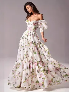 Elegant white floral organza off-the-shoulder maxi dress with a tiered skirt detail view.