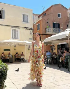 Elegant floral chiffon maxi dress with ruffles shown in a sunny outdoor setting