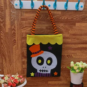 Handmade Halloween felt candy bag for kids featuring a cute skull with hat and star design