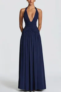 Full-length elegant navy blue halter neck pleated maxi dress with deep V-neckline