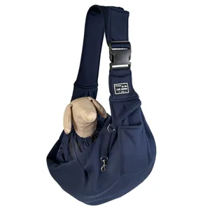 Detailed view of breathable navy blue pet sling carrier with toy dog demonstration