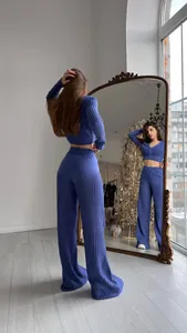 Detailed view of purple hollow knit set with high-waist wide-leg pants and cropped top