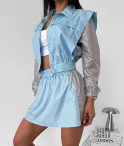 Trendy light blue and grey color block women's zip jacket and mini skirt set detail view