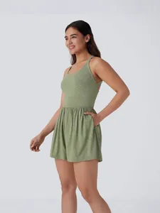 Sleeveless green athletic romper with drawstring back and functional pockets for women.