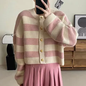 Detail view of pink and cream striped knit cardigan with elegant gold buttons