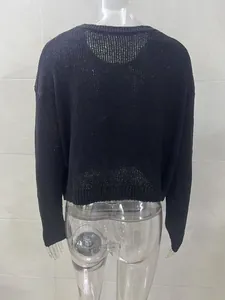 Detailed back view of a minimalist black crewneck long sleeve knit sweater with ribbed texture