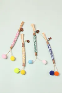Detailed view of four silvervine cat chew sticks with gall fruit and colorful raffia.