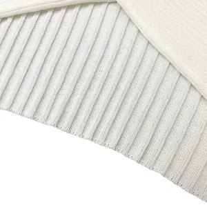 Close-up macro detail of white ribbed knit fabric texture on a women's cropped top garment