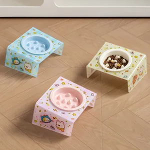 Elevated ceramic pet bowls with tilted acrylic cartoon stands for cats and dogs.