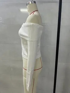 Side profile view of a white off-the-shoulder knitted sweater displayed on a mannequin.