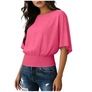 Detailed view of women's pink chiffon blouse with smocked waist and batwing sleeves