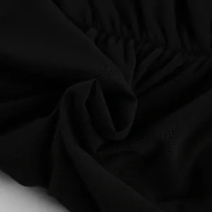 Close-up of the black breathable mesh fabric showing detailed texture and pleating.