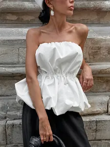 Elegant chic white strapless peplum top with cinched waist for premium summer outfits
