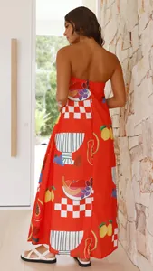 Close-up of vibrant orange strapless maxi dress with tropical fruit print design