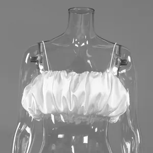 Detail view of a white ruffled satin cropped camisole top on a transparent mannequin
