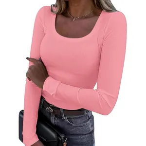 Close-up of pink slim-fit long sleeve top with ribbed texture and scoop neckline