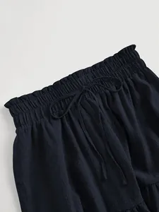 Detail of elastic drawstring waistband on navy blue textured plus size tiered skirt