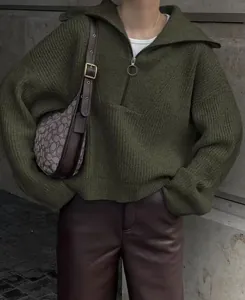 Close-up detail of retro dark green oversized knit sweater with half-zip v-neck collar