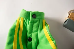 Close-up detail of green pet sports hoodie with yellow stripes and snap buttons