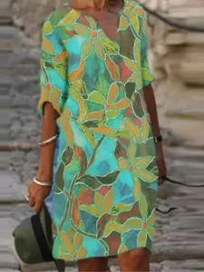 Macro detail showing the vibrant abstract floral pattern and V-neckline of this vintage dress.