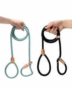 Detailed macro view of hands holding durable braided dog P-ropes in green and black colors