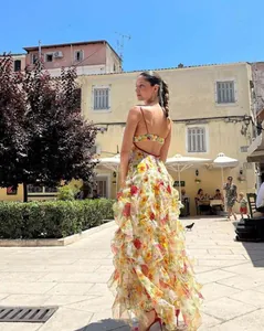 Detailed back view of a floral chiffon maxi dress with ruffles in an outdoor square