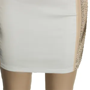 Macro detail view of white bodycon dress with rhinestone studs on sheer side panel