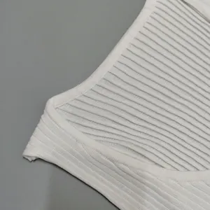 Close-up macro detail of white ribbed knit crop top neckline and soft fabric texture