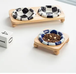Ceramic pet bowl with blue checkerboard pattern and solid oak wooden stand