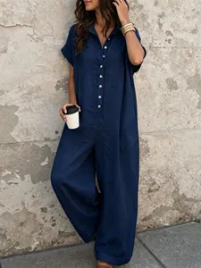 Close-up view of a stylish navy blue button-down jumpsuit with linen texture