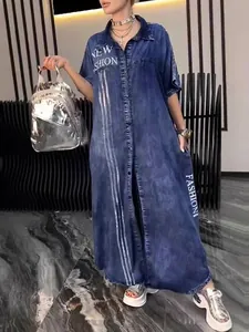 Chic long blue denim shirt dress featuring short sleeves and trendy white letter print.