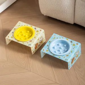 Cute ceramic slow-feeder pet bowls with tilted cartoon-patterned acrylic stands