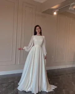 Detail view of pearlescent white wedding dress with elegant lantern sleeves