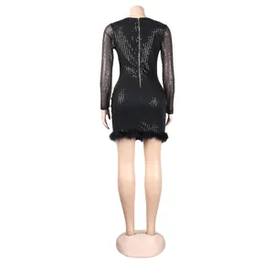 Back view of sexy black sequin mini dress with gold zipper and stylish feather trim