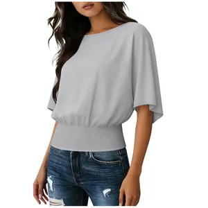 Detail view of women's gray short sleeve blouse with a stylish smocked waist design