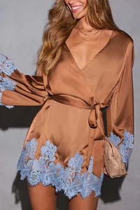 Detailed view of a brown satin wrap dress featuring intricate blue lace trim detail