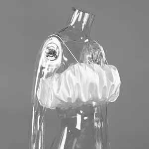 Elegant white ruffled satin cropped tube top detail on transparent mannequin torso
