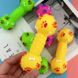 Close-up of a durable vinyl squeaky dumbbell dog toy with embossed paw print patterns