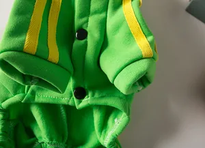 Macro detail of vibrant green pet sports hoodie featuring yellow stripes and black buttons