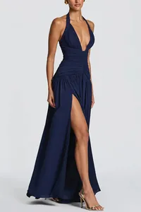 Detailed view of a navy blue halter neck evening gown with high slit and ruching.