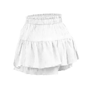 White tiered ruffled mini skirt with a smocked elastic high waist and textured fabric