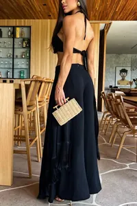 Back view of elegant black flared trousers featuring stylish side fringe detailing.