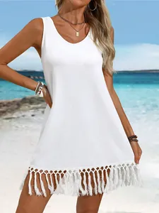 Stylish white sleeveless dress with decorative tassel hem for summer beach outings