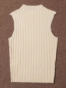 Detailed close-up of a cream-colored ribbed knit sleeveless top with fine pit strip texture